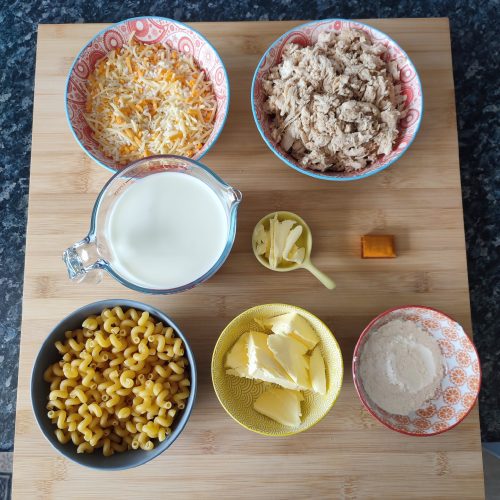 Mac and Cheese ingredients in patterned bowls on a working surface