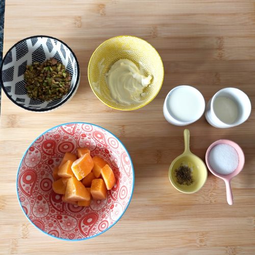 Ingredients for Mango Cardamom Pistachio Popsicles on a working surface