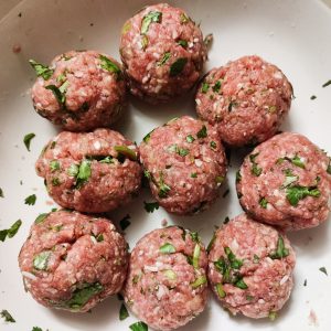 Mixed polpette ingredients (after forming into meatballs) in a bowl