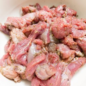 Sirloin steak marinade (after mixing) in a white bowl