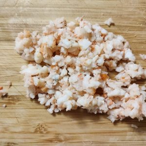 Minced shrimps on a chopping board