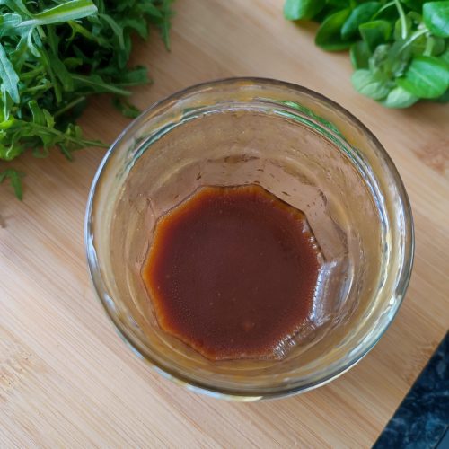 Olive Oil, Balsamic Vinegar and Honey Vinaigrette in a mason jar on a working surface