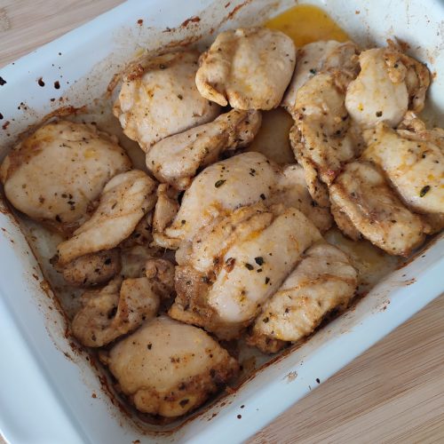 Ready to serve Baked Parmesan Chicken in a casserole dish on a working surface