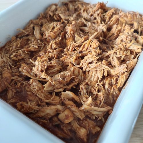 Ready to serve Instant One Pot Spicy BBQ Pulled Chicken in a white casserole dish